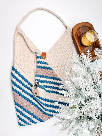 Just a Rectangle Crochet Bag laid flat showing the diagonal teal stripes and wood button
