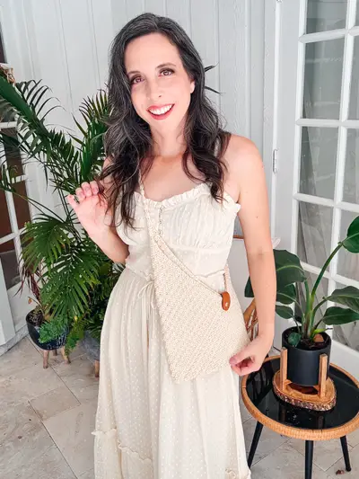 Woman carrying a cream Just a Rectangle Crochet Bag crossbody