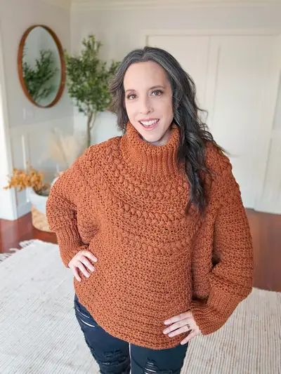 Woman wearing the rust Macchiato Crochet Poncho with a turtleneck