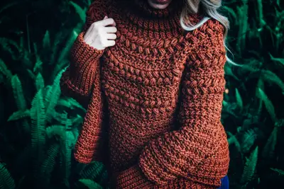 Close up of the textured rust Macchiato Crochet Poncho