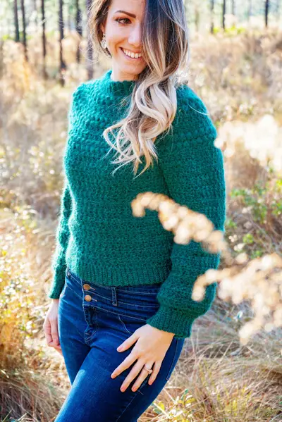 Green Macchiato Crochet Sweater worn in a sunny field