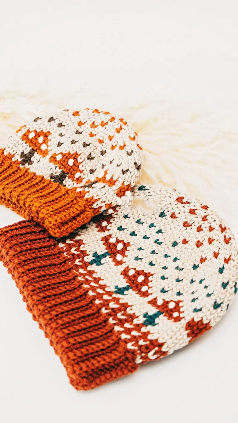 Mushroom Crochet Beanies in cream with rust mushrooms and teal dots, rust ribbed brims