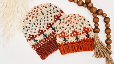 Pair of rust and cream Mushroom Crochet Beanies laid flat