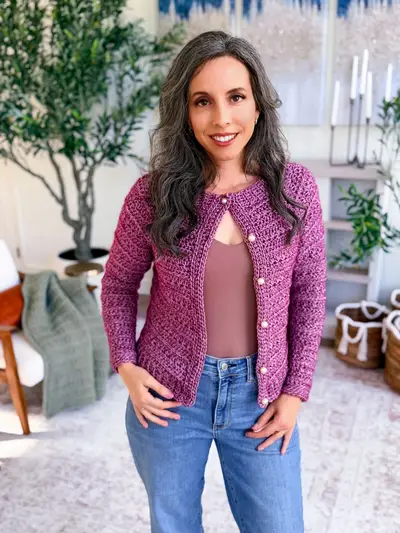 Woman wearing a plum Petal Loop Cardigan with jeans