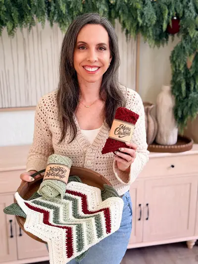 Woman holding Petal Loop Chevron Washcloths wrapped with holiday labels