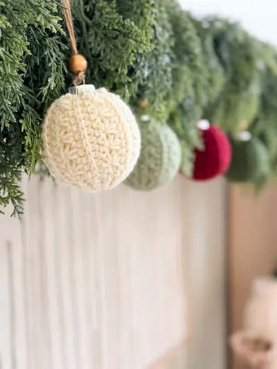 Cream Petal Loop Stitch Ornament hanging from a garland
