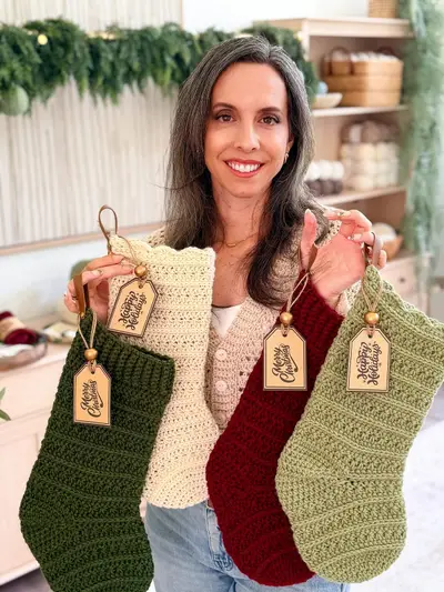 Petal Loop Stitch Stockings held up in a holiday living room