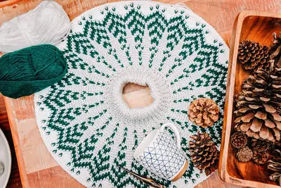 Pine Fair Isle yoke laid flat in cream and green with pine cones