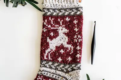 Close up of the deer motif on the burgundy Prancing Deer Holiday Stocking