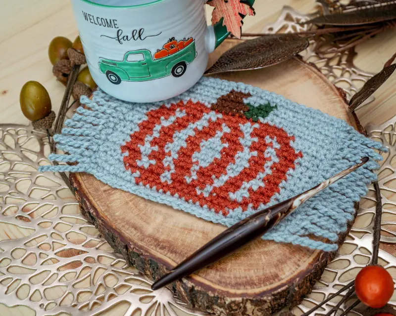 Pumpkin Coffee Mug Rug in light gray and rust under a Welcome Fall mug