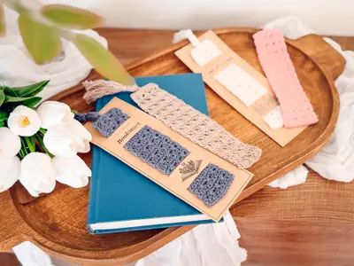 Reed Crochet Bookmarks in blue, cream and pink on a wooden tray