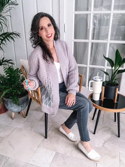 Woman sitting in the lavender Seabird Mosaic Cardi