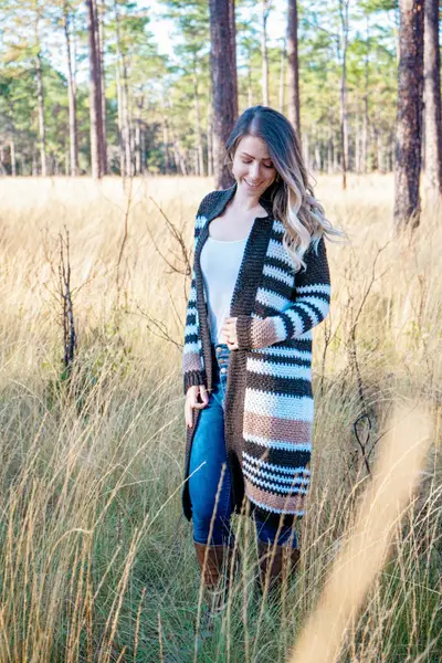 Woman in a striped Shortbread Crochet Duster standing in a tall grass field