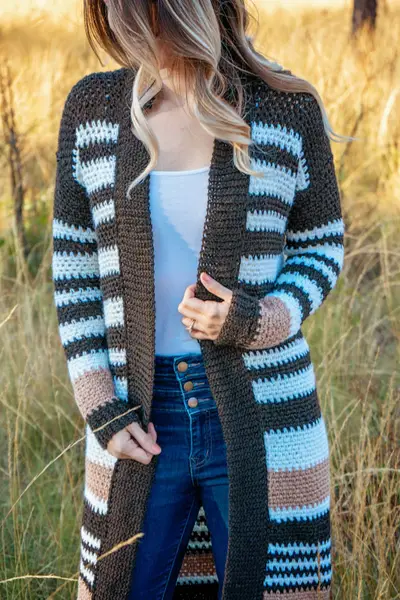 Shortbread Crochet Duster in dark brown, light blue and tan stripes outdoors