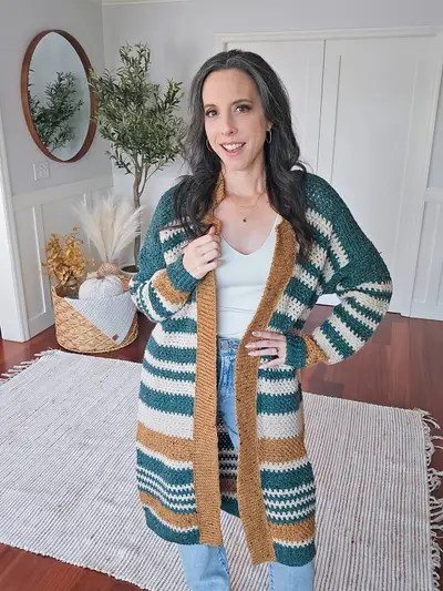 Woman wearing the Shortbread Crochet Duster in teal, cream and gold stripes