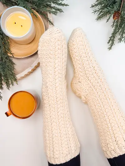 Tall cream Snowdrift Wheat Slipper Socks with a candle and tea