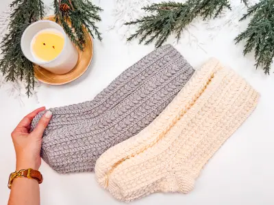 Pair of gray and cream Snowdrift Wheat Slipper Socks laid flat