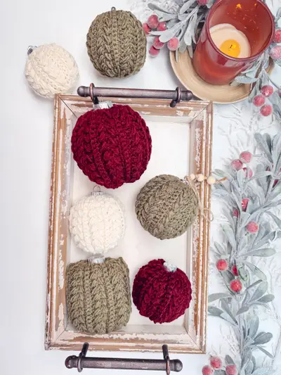 Snowy Wheat Ornaments in burgundy, olive, cream and sage on a wooden tray