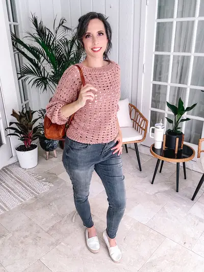 Pink Sparrow Sweater worn with jeans and a brown purse
