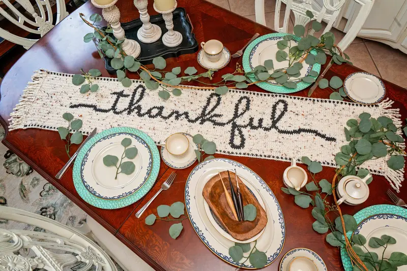 Thankful Crochet Table Runner on a set dining table with eucalyptus and teal plates