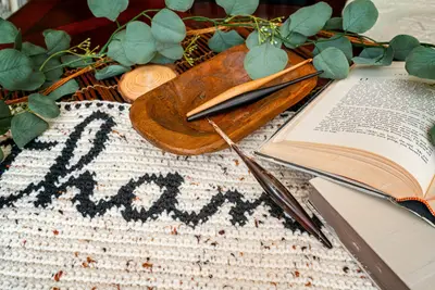 Black script on the oatmeal Thankful runner beside a wooden bowl and open book