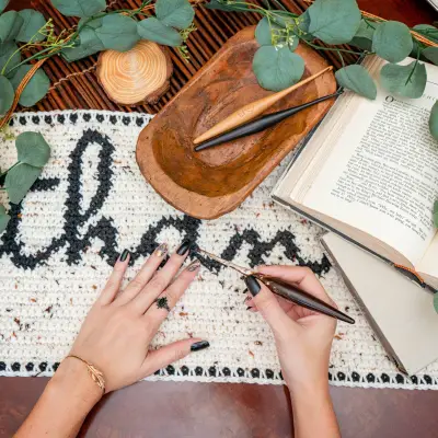 Hands crocheting the Thankful Crochet Table Runner with a wooden hook