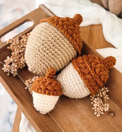Wheat Stitch Acorns in tan and cream with rust caps on a wooden tray