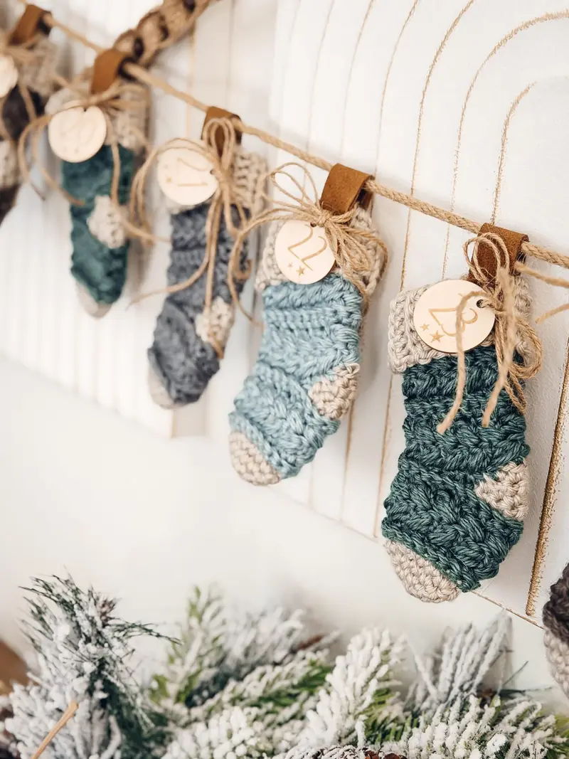Wheat Stitch Advent Crochet Stockings in blue and gray hanging with numbered tags