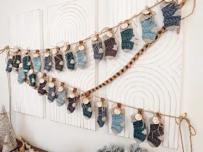 Garland of 24 tiny Wheat Stitch Advent Crochet Stockings on a white wall