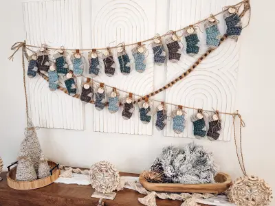 Wheat Stitch Advent Crochet Stockings garland hung above a console table