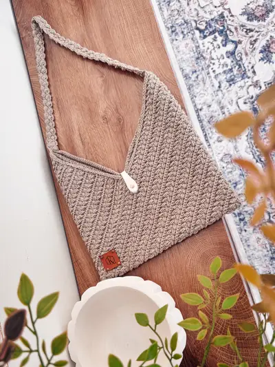 Tan Wheat Stitch Crochet Bag laid flat with a wood toggle and leather tag