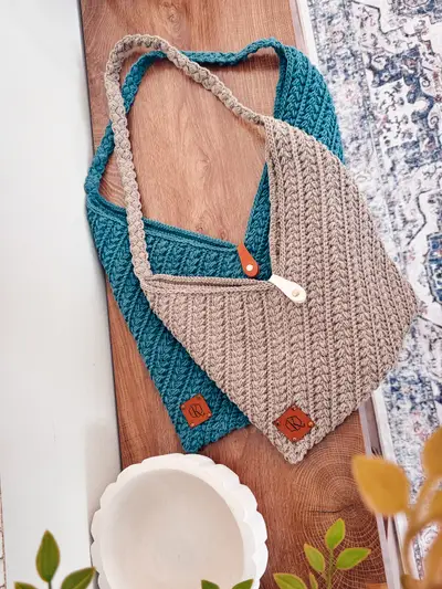 Tan and teal Wheat Stitch Crochet Bags laid on a wooden board