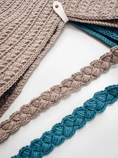 Close up of the braided straps on tan and teal Wheat Stitch Crochet Bags