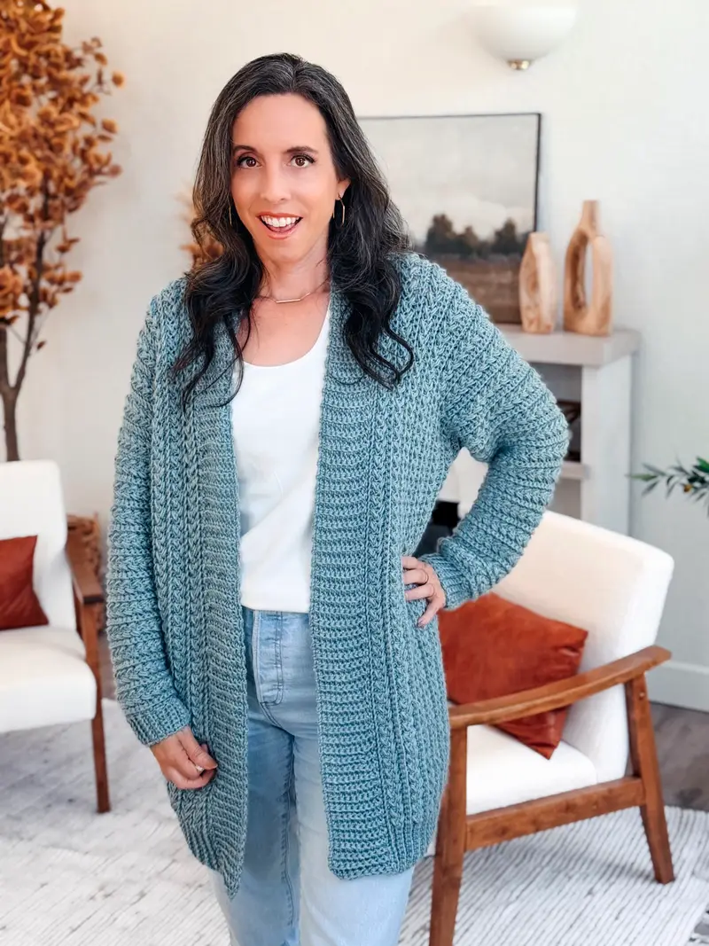 Woman wearing the long blue Wheat Stitch Crochet Cardigan with jeans