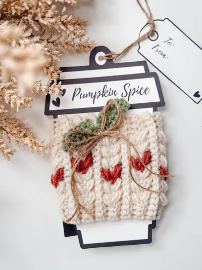 Cream Wheat Stitch Pumpkin Cozy with red hearts and a twine leaf