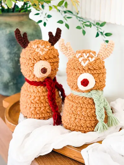 Two Wheat Stitch Crochet Reindeer in caramel with red and sage scarves