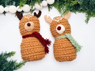 Wheat Stitch Crochet Reindeer pair laid flat with greenery