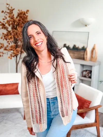 Smiling woman in a blush and cream Wheat Stitch Crochet Scarf