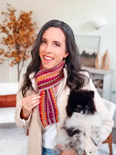 Woman in a multicolor Wheat Stitch Crochet Scarf holding her pomeranian