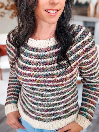 Woman wearing the Wheat Stitch Crochet Sweater in cream with speckled multicolor stripes
