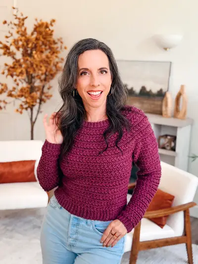 Woman wearing the burgundy Wheat Stitch Crochet Sweater with jeans