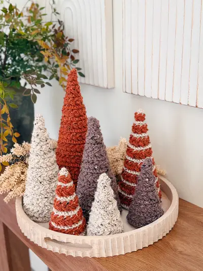Tray of fall Wheat Stitch Crochet Trees in rust, cream and striped colors