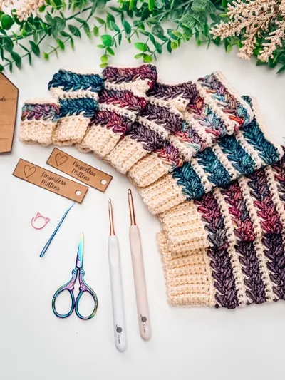 Wheat Stitch Fingerless Mittens laid flat with gift tags and crochet hooks