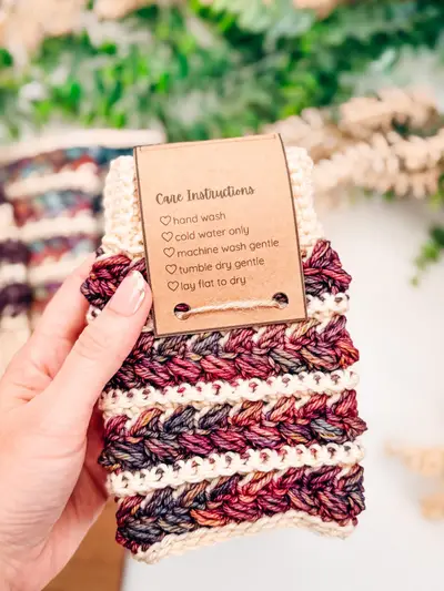 Wheat Stitch Fingerless Mitten held with a care instructions tag
