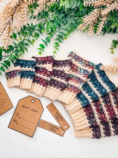 Two pairs of Wheat Stitch Fingerless Mittens with kraft tags