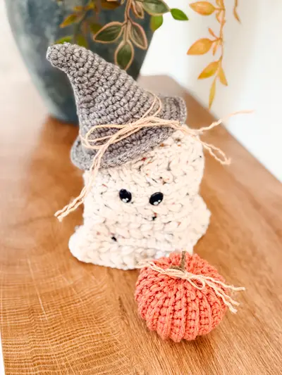 Speckled Wheat Stitch Ghost with a gray witch hat and a rust pumpkin