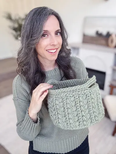 Woman holding a sage Wheat Stitch Nesting Basket