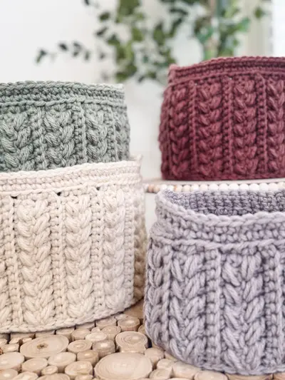 Close up of the wheat stitch texture on sage, burgundy, cream and lavender baskets