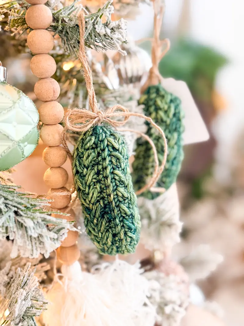 Green Wheat Stitch Pickle Ornaments hanging on a Christmas tree