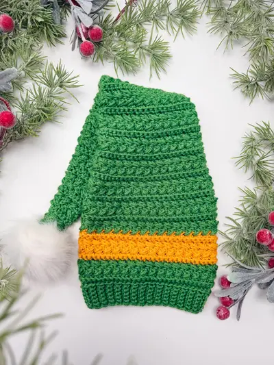 Green Wheat Stitch Elf Hat with a yellow band and white pom pom